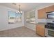 Bright dining area adjacent to kitchen with tile floors and a modern chandelier at 21511 N 79Th Dr, Peoria, AZ 85382