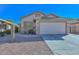 Single-story home showcasing a two-car garage and desert landscaping at 21511 N 79Th Dr, Peoria, AZ 85382