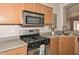 Well-lit kitchen features stainless steel appliances, gas range, and light wood cabinets at 21511 N 79Th Dr, Peoria, AZ 85382