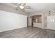 Spacious living room with hardwood floors, neutral walls, and a decorative ceiling fan at 21511 N 79Th Dr, Peoria, AZ 85382