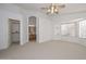 Bright main bedroom with a ceiling fan, a large window, and an en-suite bathroom at 21511 N 79Th Dr, Peoria, AZ 85382