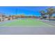 View of a community tennis court with lighting and fenced perimeter at 21511 N 79Th Dr, Peoria, AZ 85382