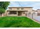 Backyard view of home features a manicured lawn, large patio and upper balcony at 21732 N 86Th Ln, Peoria, AZ 85382