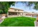 Exterior view of the home from the backyard showing the covered patio and pool at 21732 N 86Th Ln, Peoria, AZ 85382