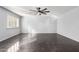 Spacious bedroom featuring dark tile flooring, neutral walls, and modern ceiling fan at 21732 N 86Th Ln, Peoria, AZ 85382