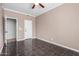 Bedroom showcasing a tile floor, door to a closet, and access to other rooms at 21732 N 86Th Ln, Peoria, AZ 85382