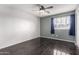 Bright bedroom features tile flooring, ceiling fan, and a window with natural light at 21732 N 86Th Ln, Peoria, AZ 85382