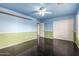 A bedroom painted two-tone featuring a ceiling fan and tile floors at 21732 N 86Th Ln, Peoria, AZ 85382