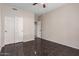 Neutral bedroom with a ceiling fan, closet, and tile floors for easy maintenance at 21732 N 86Th Ln, Peoria, AZ 85382