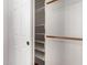 Closet with door ajar features shelving and hanging options at 21732 N 86Th Ln, Peoria, AZ 85382