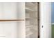 A bedroom closet features a rod and shelves for ample storage space at 21732 N 86Th Ln, Peoria, AZ 85382