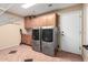 Laundry room features cabinetry, tile flooring, and washer and dryer at 21732 N 86Th Ln, Peoria, AZ 85382