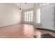 Bright living room showcasing a high ceiling, a ceiling fan, large windows, and tiled floors at 21732 N 86Th Ln, Peoria, AZ 85382