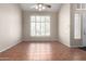 Bright living room featuring a ceiling fan, large windows, and tiled floors at 21732 N 86Th Ln, Peoria, AZ 85382