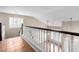 View of a tiled upstairs loft featuring a railing, high ceilings, and natural light at 21732 N 86Th Ln, Peoria, AZ 85382