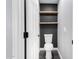 Compact powder room with floating shelves, matte black accent wall, and modern toilet at 21732 N 86Th Ln, Peoria, AZ 85382