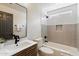 Modern bathroom with gray and white tile, features tub and black fixtures at 21824 N 32Nd Ave, Phoenix, AZ 85027