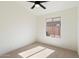 Well-lit bedroom with neutral carpet and a large window overlooking the backyard at 21824 N 32Nd Ave, Phoenix, AZ 85027