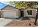 Charming single-story home with well-manicured front yard and a two-car garage at 21824 N 32Nd Ave, Phoenix, AZ 85027