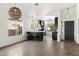 Open concept kitchen with stainless steel appliances, dark cabinets, bar seating, and a large window at 21824 N 32Nd Ave, Phoenix, AZ 85027