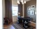 Contemporary home office with stylish desk, decor, and modern chandelier lighting at 2195 N Peden Dr, Chandler, AZ 85225