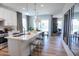 Open-concept kitchen with island seating leading to a living area with a patio view at 2195 N Peden Dr, Chandler, AZ 85225