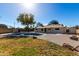 Spacious backyard with a refreshing pool, lush grass, and mature trees, creating a tranquil oasis at 2201 S Evergreen Rd, Tempe, AZ 85282