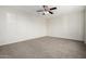 A carpeted bedroom, featuring a ceiling fan and a neutral color scheme at 2201 S Evergreen Rd, Tempe, AZ 85282