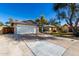 Charming single-story home featuring a well-manicured lawn, desert landscaping, and a two-car garage at 2201 S Evergreen Rd, Tempe, AZ 85282