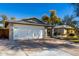 Two-car garage attached to a charming single-story home with desert landscaping at 2201 S Evergreen Rd, Tempe, AZ 85282