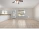 Bright living room featuring tile floors, ceiling fan, and a large window for natural light at 2201 S Evergreen Rd, Tempe, AZ 85282