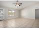 Tile living room featuring a decorative security door and a window letting in natural light at 2201 S Evergreen Rd, Tempe, AZ 85282