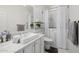 Bright bathroom with white marble countertops and a walk-in bathtub at 24416 S Lakestar Dr, Sun Lakes, AZ 85248