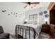 Comfortable bedroom featuring a ceiling fan and a decorative metal bed frame with natural light at 24416 S Lakestar Dr, Sun Lakes, AZ 85248