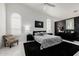 Stylish bedroom with zebra patterned bedding, accent chair and arched windows at 24416 S Lakestar Dr, Sun Lakes, AZ 85248