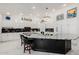 Bright kitchen featuring white cabinetry, a large island with marble countertop, and modern appliances at 24416 S Lakestar Dr, Sun Lakes, AZ 85248