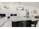 Bright kitchen featuring white cabinetry, a large island with marble countertop, and modern appliances at 24416 S Lakestar Dr, Sun Lakes, AZ 85248