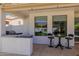 Outdoor kitchen with a built-in BBQ, bar seating, and views of the pool and backyard at 24416 S Lakestar Dr, Sun Lakes, AZ 85248