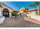 Relaxing outdoor patio featuring brick pavers, comfortable seating, and lush landscaping at 24416 S Lakestar Dr, Sun Lakes, AZ 85248