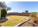 Backyard with a curved grassy area and a gravel border against a block wall at 2640 S Los Altos Dr, Chandler, AZ 85286