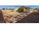 A spacious backyard featuring decorative rock, a block wall, and drought resistant landscaping at 2640 S Los Altos Dr, Chandler, AZ 85286