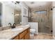 Bathroom with large glass shower, granite counters, light walls, and tile floors at 2640 S Los Altos Dr, Chandler, AZ 85286