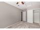 Bedroom featuring carpet floors, a ceiling fan, and a double door closet at 2640 S Los Altos Dr, Chandler, AZ 85286