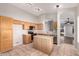 Functional kitchen with tile flooring, wooden cabinetry, an island, and stainless steel appliances at 2640 S Los Altos Dr, Chandler, AZ 85286