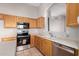 Well-lit kitchen features wooden cabinets, stainless steel appliances, tile floor, and light countertops at 2640 S Los Altos Dr, Chandler, AZ 85286