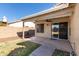 Covered patio with ceiling fan extends to the grassy backyard at 2640 S Los Altos Dr, Chandler, AZ 85286