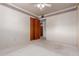 Bedroom with white walls, neutral carpet, ceiling fan, and closet with sliding wood doors at 2806 W Marshall Ave, Phoenix, AZ 85017