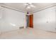 Bedroom with white walls, neutral carpet, a ceiling fan, and an access door to the bathroom at 2806 W Marshall Ave, Phoenix, AZ 85017