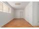 Bedroom with a wood floor, a big window with white trim, and white painted walls at 2806 W Marshall Ave, Phoenix, AZ 85017