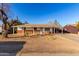 Charming single-story home featuring a red brick facade and a covered carport, perfect for parking at 2806 W Marshall Ave, Phoenix, AZ 85017